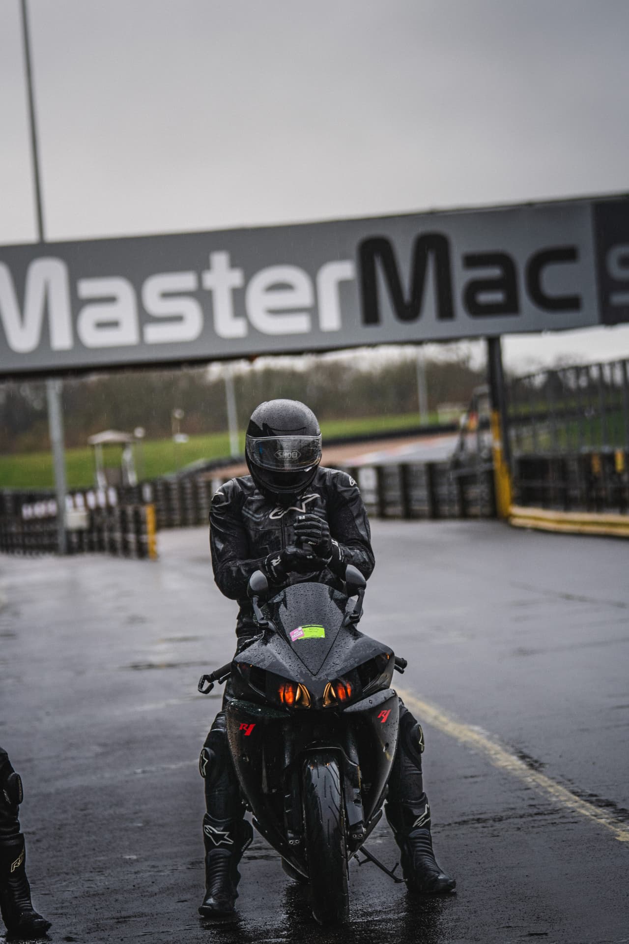 Under the Gantry: A Rider's Pause — example photograph.
